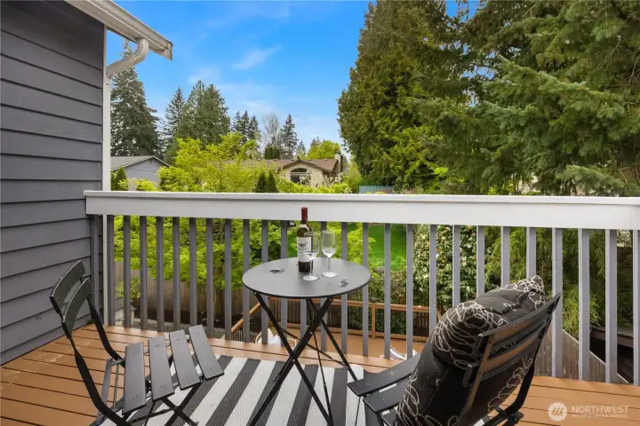 Private balcony off of the primary suite overlooks the backyard.
