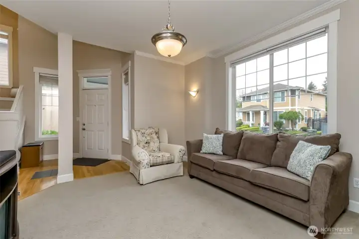 Beautiful front living room is light and bright and overlooks the beautiful front yard.