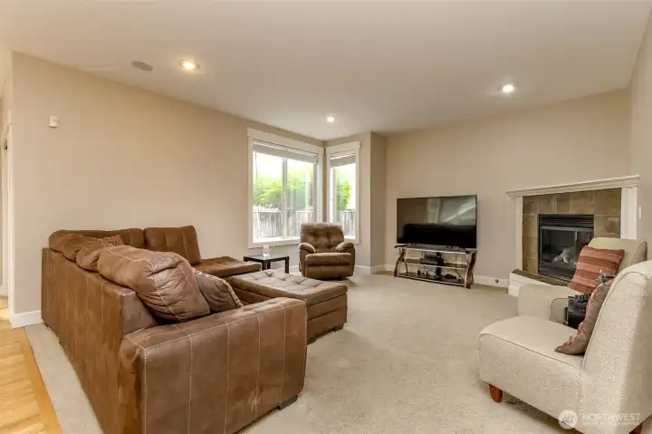 Big corner windows look out over your backyard and cozy fireplace adds warmth to the natural light!