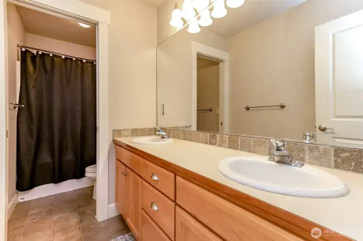 Main bath on the upper level with double vanity.