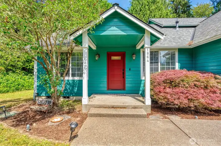 The front porch offers covered dry entryway and garden beds. The front porch offers covered dry entryway and garden beds.