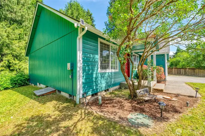 The minimal low maintenance front yard leads you around to side yard on each side of the home. This is to the left side. The minimal low maintenance front yard leads you around to side yard on each side of the home. This is to the left side.
