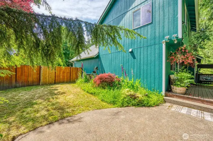 Rear/side yard with garden space. Rear/side yard with garden space.