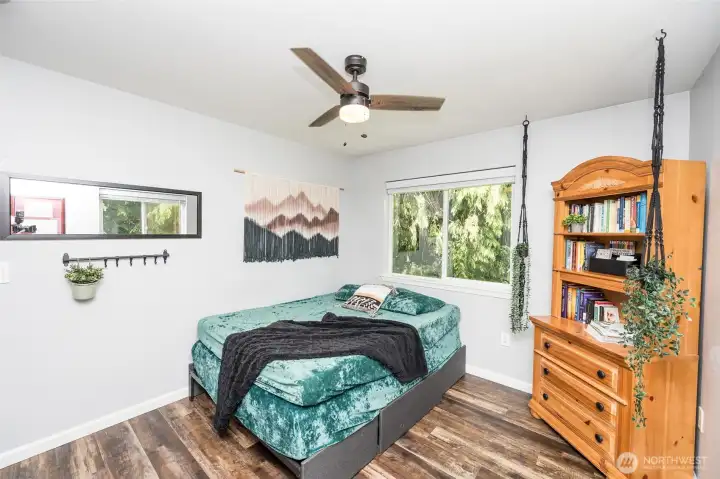 First bedroom with window treatments and ceiling fan. First bedroom with window treatments and ceiling fan.