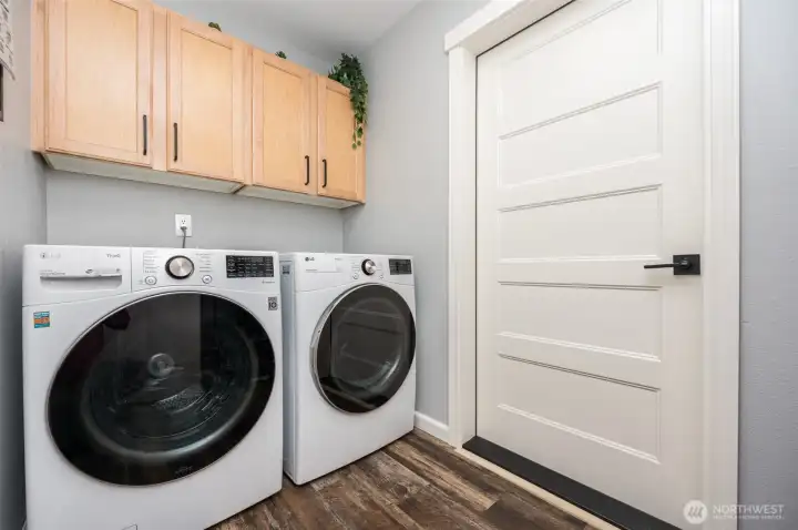 Mud room off garage is laundry with built in cabinetry and shelving. Mud room off garage is laundry with built in cabinetry and shelving.