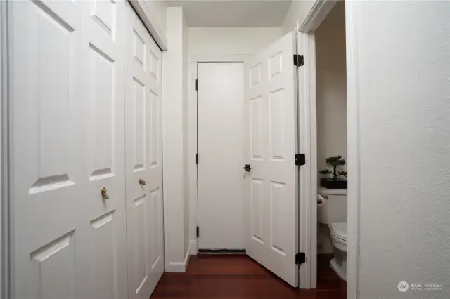 Hallway off family room to 1/2 bath, utility area & garage door.