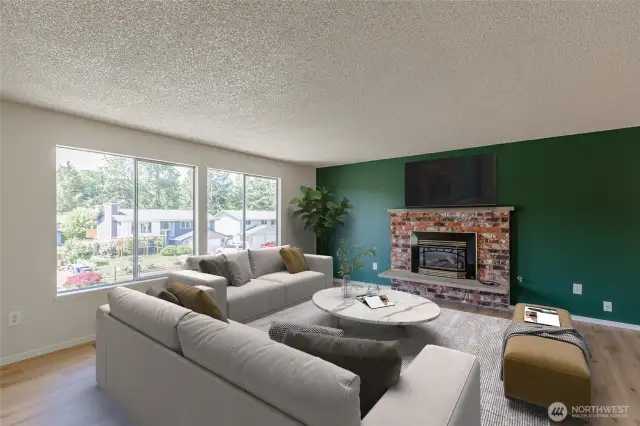 The living room has a wall of windows and laminate floors. Virtually staged.