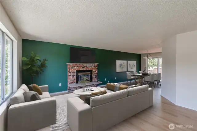 Brick gas fireplace flows into the dining area. Virtually staged.