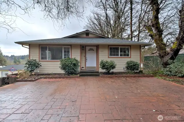 Large patio area in front of upper unit entrance to home.