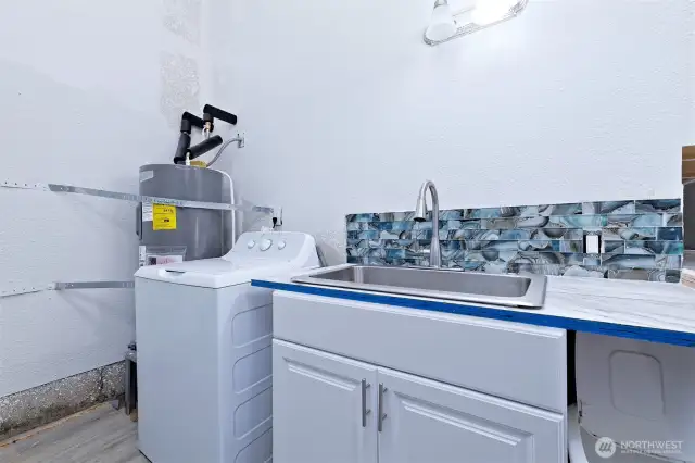 Sink and new H2O heater in garage.