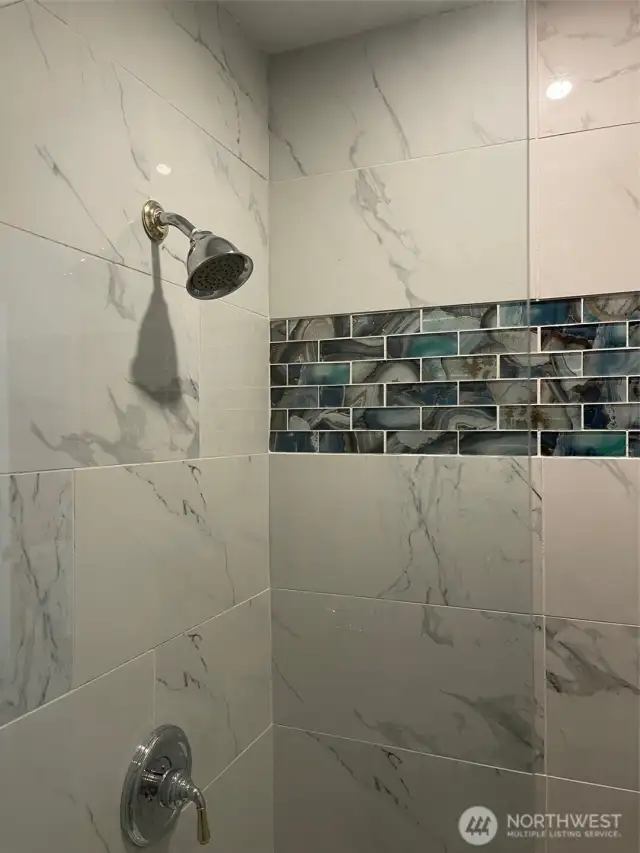Beatiful Tiled Shower in garage bathroom.