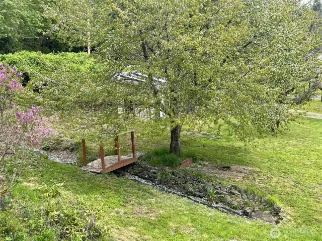 Side yard with bridge over the water.