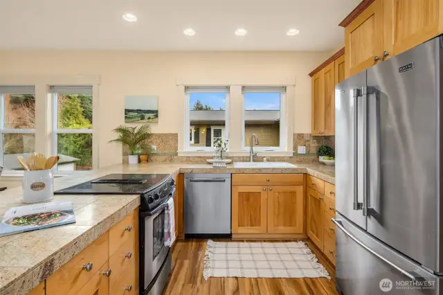 The kitchen is thoughtfully designed with an abundance of storage and ample counter space, offering a perfect blend of functionality and style.