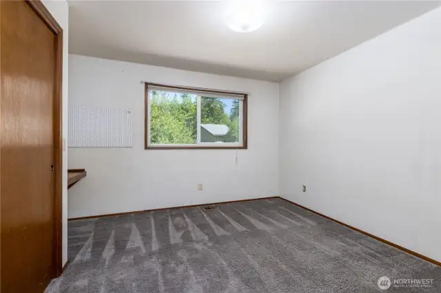 Bdr 1 with a desk area beside the closet