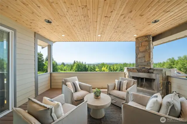 Covered patio with wood burning fireplace.