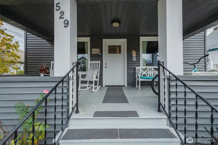 Expansive covered porch adds to the Tudor character and offers plenty of space for seating and décor.
