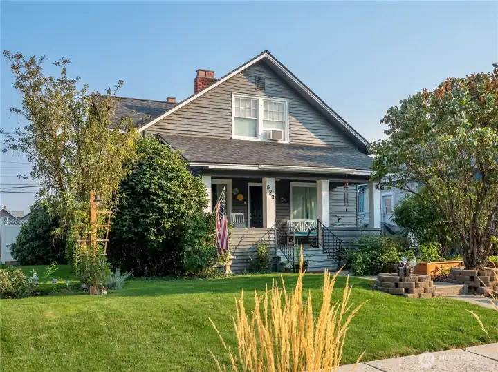 Charming front entry with Tudor details, fresh landscaping, and natural light throughout.