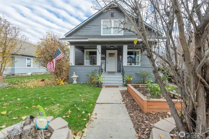 Charming front entry with Tudor details, fresh landscaping, and natural light throughout.