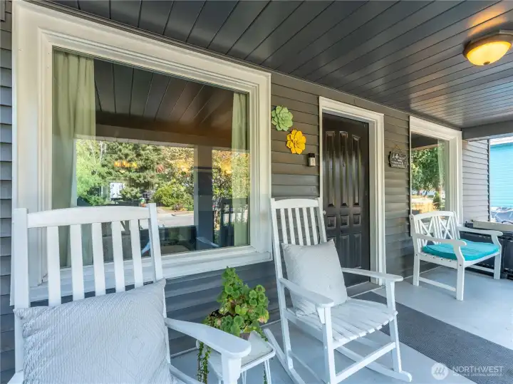 Expansive covered porch adds to the Tudor character and offers plenty of space for seating and décor.
