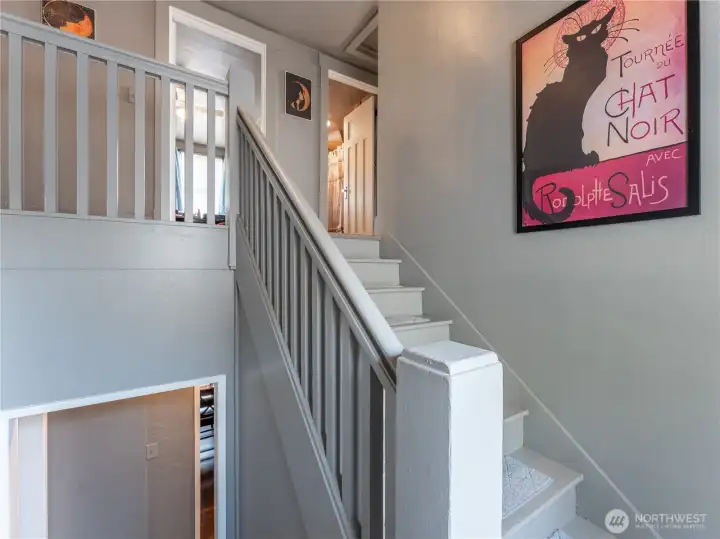 Charming staircase leading to three additional bedrooms and full bath.