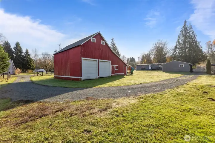 The gravel driveway connects both gated entrances on the property.