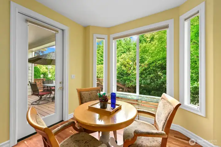 Informal dining Nook off the Kitchen surrounded by large Windows & Glass Door to the Deck.