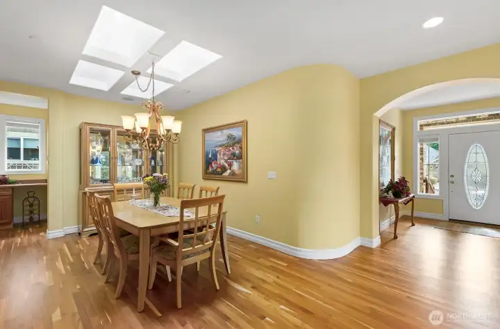 Dining Room features over-sized Skylight.  Small workstation off the dining space in the background.