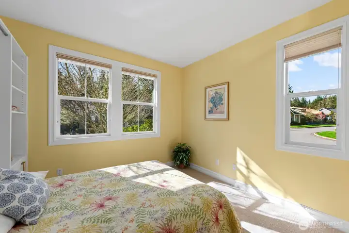 Guest Bedroom is filled with natural light.   Murphy Bed with built-in shelving and storage.