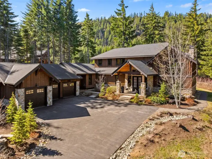 Set on a .84-acre parcel, this 3,998 sq ft home offers unmatched craftsmanship and sweeping views of Easton Ridge. The 1,200 sq ft three-bay garage accommodates up to four vehicles, featuring a tandem bay pre-wired with a 220V outlet and ready for a car lift, PennTek floor coating, a mini-split for year-round comfort, an interior hot/cold hose bib, a sink and cabinet unit, an 8.5 x 7.5 ft workshop area and a dedicated trash room. Set on a .84-acre parcel, this 3,998 sq ft home offers unmatched craftsmanship and sweeping views of Easton Ridge. The 1,200 sq ft three-bay garage accommodates up to four vehicles, featuring a tandem bay pre-wired with a 220V outlet and ready for a car lift, PennTek floor coating, a mini-split for year-round comfort, an interior hot/cold hose bib, a sink and cabinet unit, an 8.5 x 7.5 ft workshop area and a dedicated trash room.