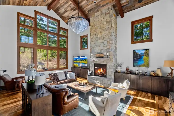 The abundant natural light great room boasts a floor-to-ceiling stone fireplace with a magnificent 44" RH crystal prism chandelier. The abundant natural light great room boasts a floor-to-ceiling stone fireplace with a magnificent 44" RH crystal prism chandelier.