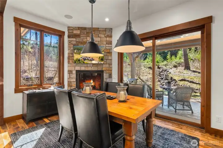 Light and bright casual dining area seats 6 with floor-to-ceiling stone fireplace and Restoration Hardware pendant lights. Light and bright casual dining area seats 6 with floor-to-ceiling stone fireplace and Restoration Hardware pendant lights.