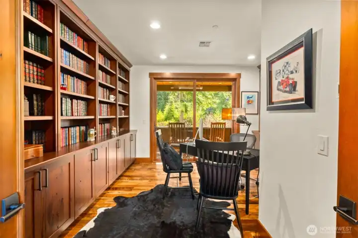 Whether used as an executive office or bedroom four, this second floor space features floor-to-ceiling custom wood bookcases and cabinetry, while sliding glass doors invite you to a balcony with stunning ridgeline views, with the potential for a convertible ensuite. Whether used as an executive office or bedroom four, this second floor space features floor-to-ceiling custom wood bookcases and cabinetry, while sliding glass doors invite you to a balcony with stunning ridgeline views, with the potential for a convertible ensuite.