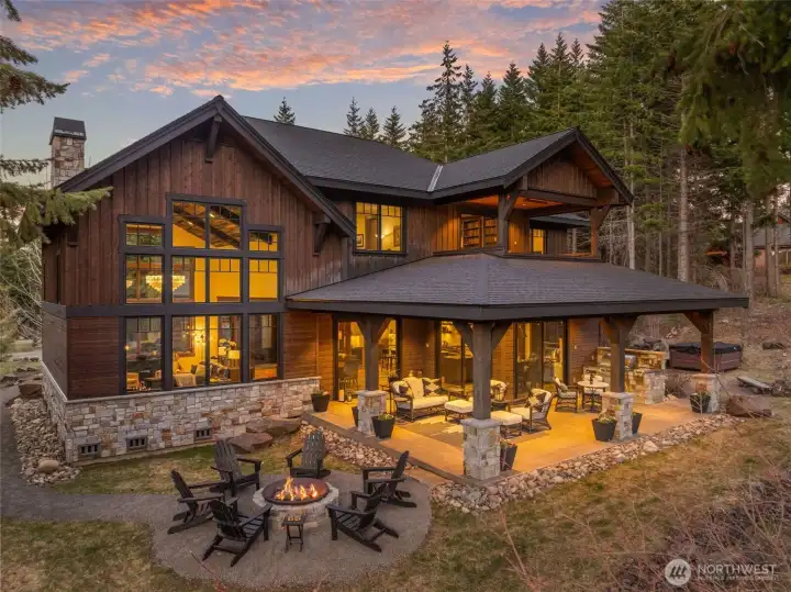This custom home is simply perfect, and every detail shines in the evening glow. Gather around the oversized custom fire pit to share laughs and stories with those you love. This custom home is simply perfect, and every detail shines in the evening glow. Gather around the oversized custom fire pit to share laughs and stories with those you love.