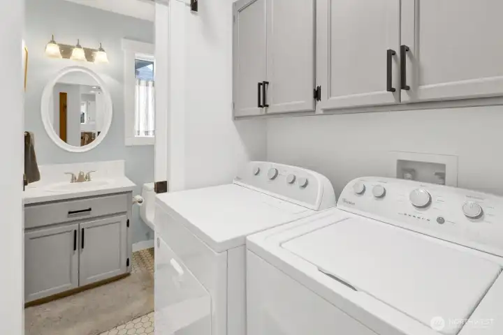 Laundry room just off the garage with a guest ½ bath beyond.