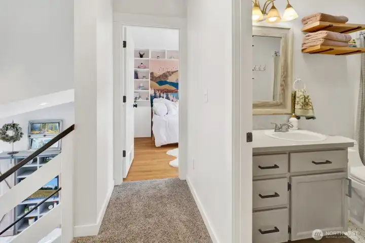 Two upstairs bedrooms with a centrally located bathroom—perfect for family or guests.