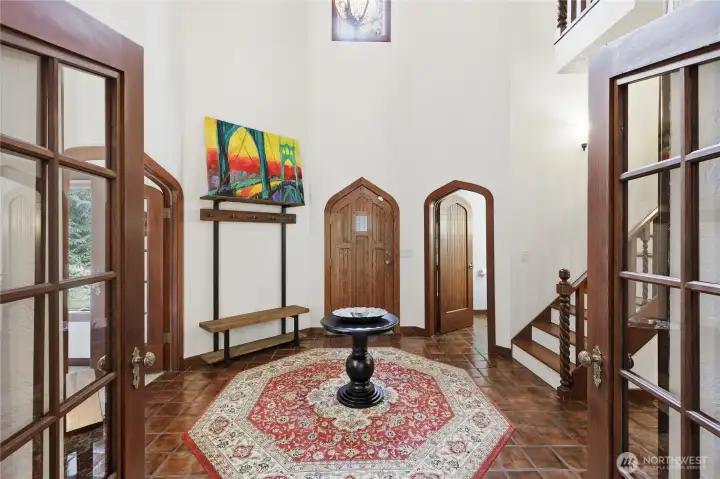 Formal entry with custom millwork and beautifully arch doors