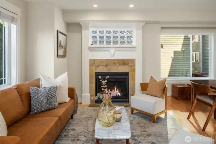 Living area with cozy gas fireplace adds warmth and charm. Stunning millwork detail in perfect condition surround the fireplace.