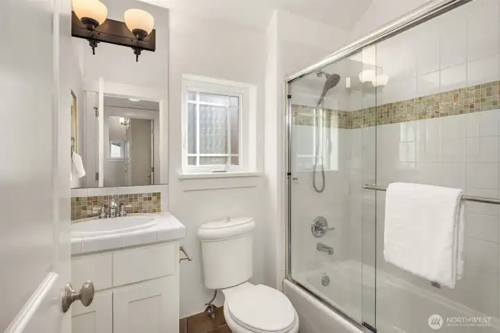 Third bedroom on lower floor with big window and deep closet.