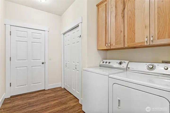 Laundry room with cupboards and a closet. Door leads to the garage.