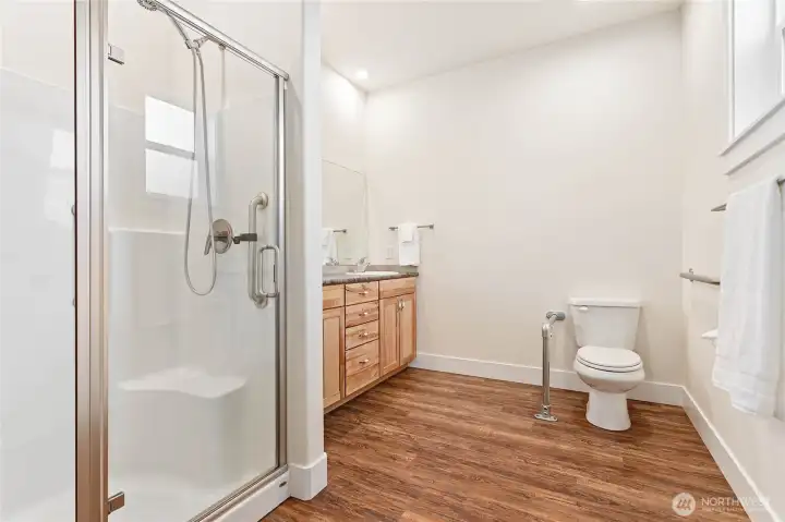 Primary bathroom has a grab bar by the toilet.