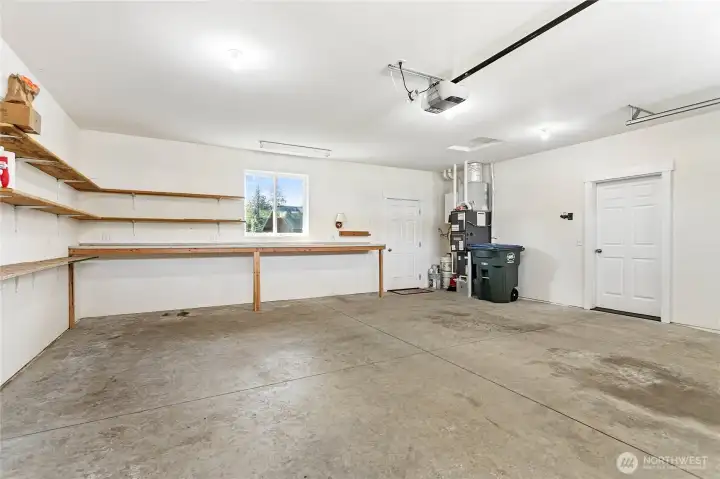 Two car garage w/door to back yard & lots of built in shelving.