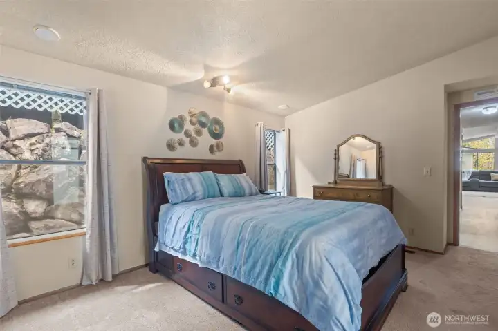 large master bedroom with walk in closet and en suite bathroom