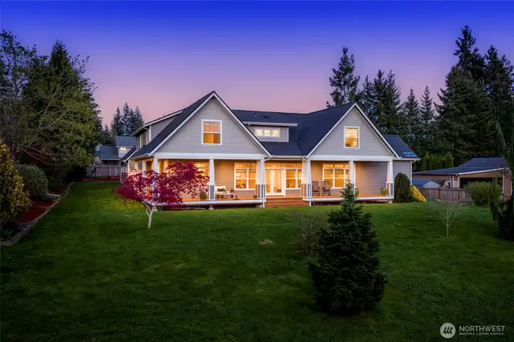 Backyard view of the house with large covered porch
