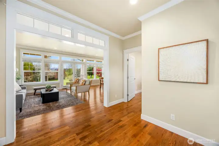 Entryway with gables, leading into open concept living/dinning area. French doors lead outside to covered porch and windows provide tons of natural light.