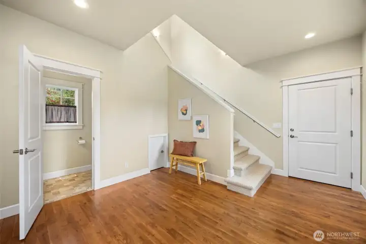 Garage entry way with Half bath and stairs that lead to upstairs