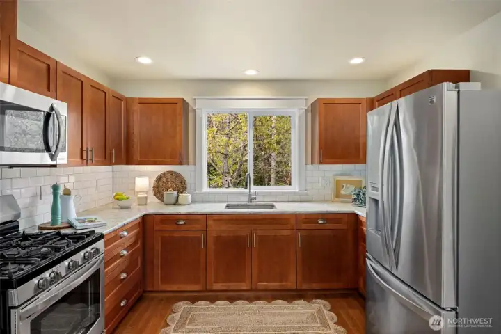 Upstairs kitchen, ideal for multigenerational living. Kitchen has stainless steel appliance & granite countertops.
