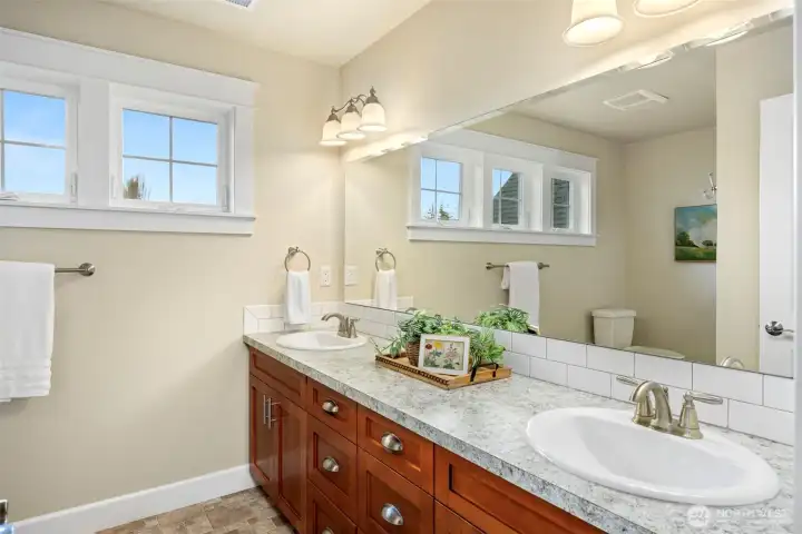 Upstairs 3/4 bath, with dual sinks, toilet and shower.