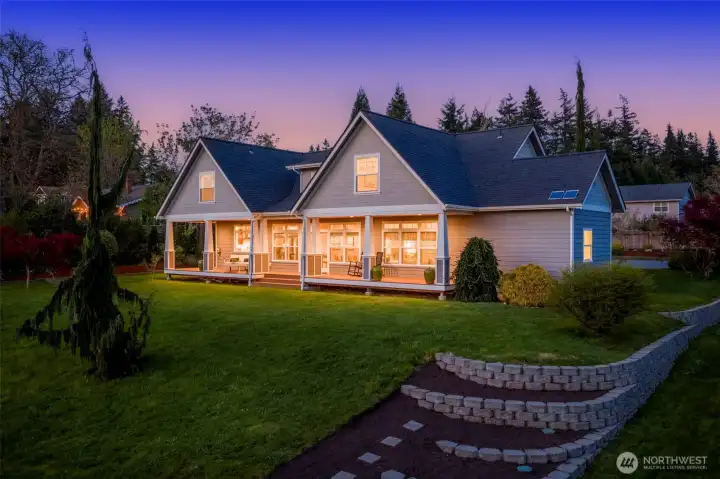 Twilight view of back of the house and garden area.