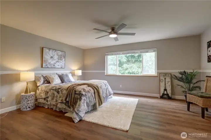 Spacious primary Bedroom looking out to the the lush backyard.