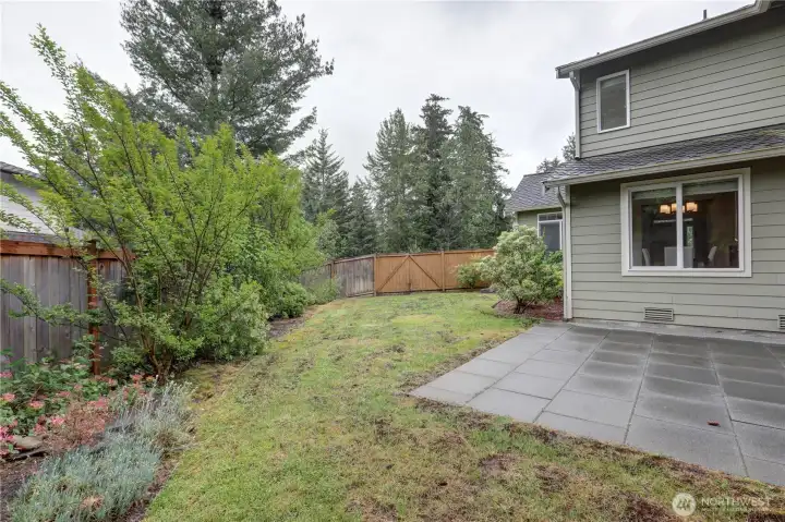 Side of the house with a grassy area, great for kids & pets.